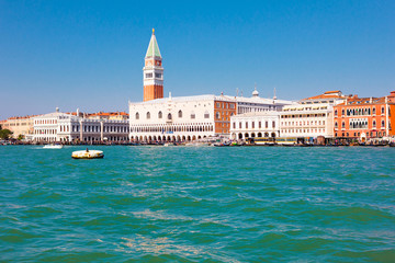 Fototapeta na wymiar View of Saint Mark's square in Venice, Italy. Blue lagoon and beautiful cityscape.