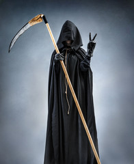 Grim Reaper showing Victory sign. Photo of silhouette grim reaper showing Victory gesture or two...