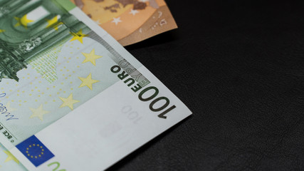 money in an envelope on a black notepad background