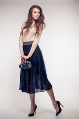 Fototapeta premium A studio portrait of a sexy hot lady in black skirt.