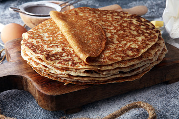 French crepes or pancakes with ingredient on grey background