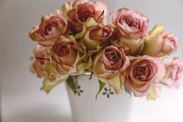 Pink roses in metal basket. Vintage decor concept. Valentine's day concept
