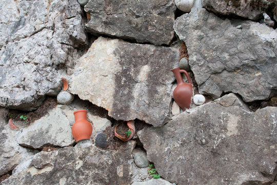 Broken earthen jars in wall