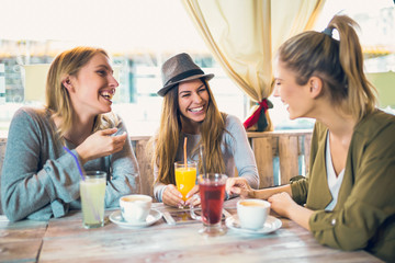 Friends enjoying in conversation and drinking coffee.