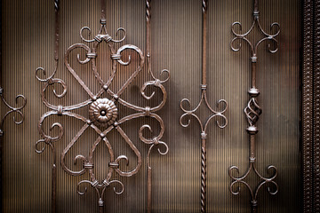 Details, structure and ornaments of forged iron gate. Floral decorative ornament, made from metal....