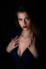 Fototapeta premium Sexy young blonde with red lips on a black background