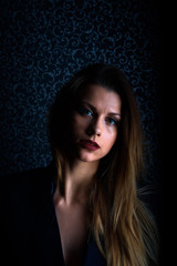 Fototapeta premium Sexy young blonde with red lips on a black background