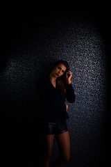 Sexy young blonde with red lips on a black background