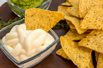 Background of corn tortillas or Nachos fried over an open fire with caeso sauce and Salsa. Copy space.