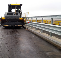 Machinery leveling of the bitumen