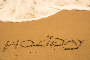  holiday writing concept on sand