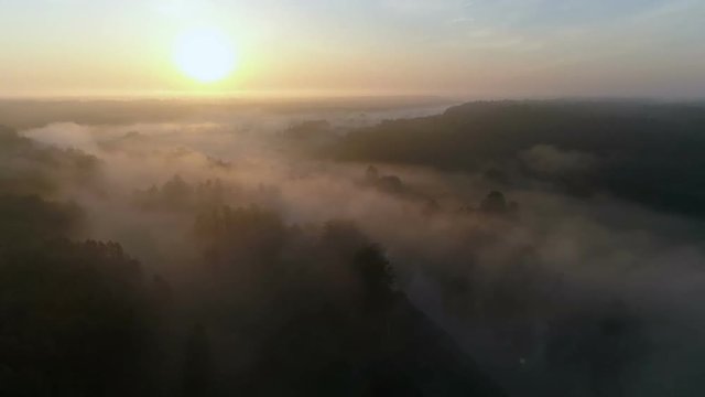 Sunrise Drone footage above the white fog and river