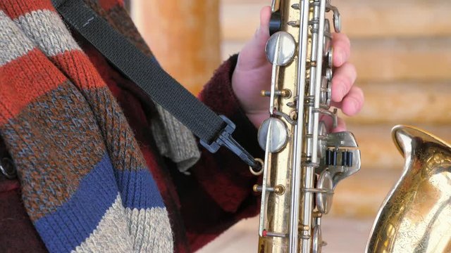 saxophonist plays the saxophone, in winter
