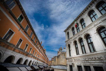 Obraz premium historic houses in Venice, Italy at cloudy day and the sitting couple on the foreground