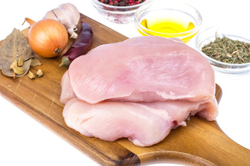 Raw chicken meat fillet on cutting board