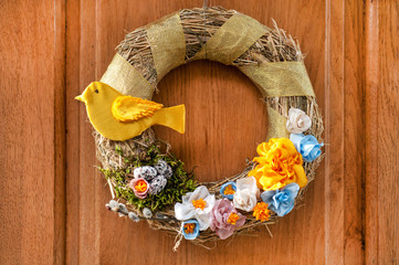 A gentle Easter wreath hangs on the door