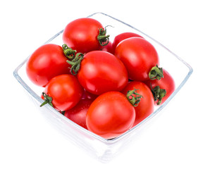 Small red cocktail tomatoes in glass bowl