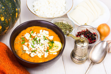 Pumpkin cream soup with goat cheese