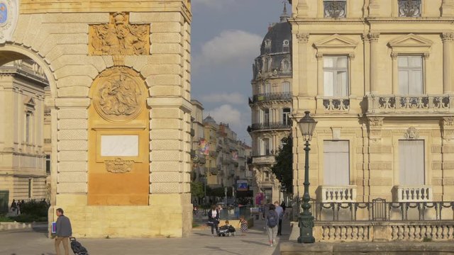 People walking by Porte du Peyrou