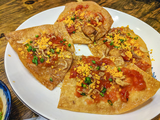 Vietnamese Girdle Cake street food consisting of rice pancakes with vegetables and chilli sauce.