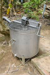 Hand operated centrifuge used to spin honey from honeycombs at a bee farm, Vietnam