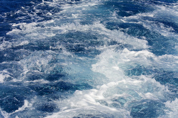 Turbulence made by the foam of sea water from a high-speed yacht on the surface of the sea. Image for background, wallpaper or desktop, abstract texture