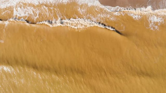 Aerial view of clay-polluted sea coast. Muddy sea water. Environmental contamination. Chemical accident. Video shot with a drone.