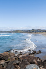 View of the Ocean Waves breaking on the Beach, in Morrow Bay, California