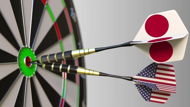 Flags of Japan and the USA on darts hitting bullseye of the target. International cooperation or competition conceptual animation