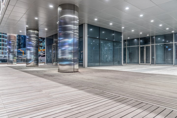 Empty wooden footpath front modern building.