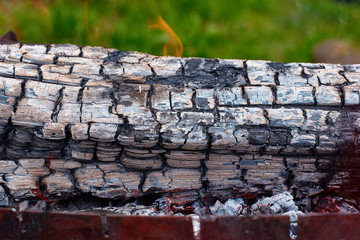 Close up Brazier with burning coals and logs in the grill as a background. outdoor recreation in the weekend