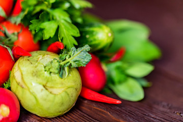 Fresh vegetables and herbs on wooden table
