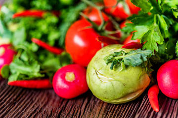 Fresh vegetables and herbs on wooden table