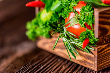 Fresh vegetables and herbs in wooden box