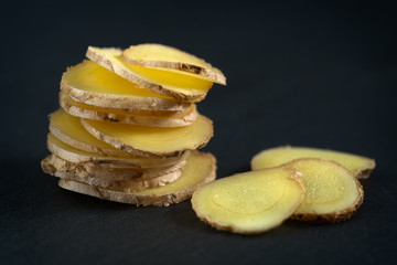 sliced ginger on a stone background