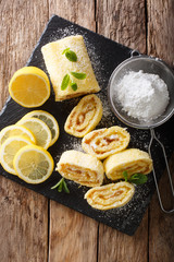 English lemon sweet roll cake with a fruity curd close-up. Vertical top view from above
