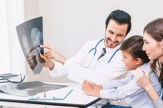 Doctor showing the X-ray photo to little boy in hospital.healthcare and medicine