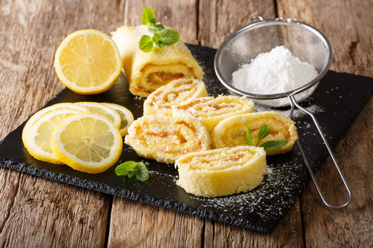 Sweet lemon roll with curd, with mint and powdered sugar close-up. horizontal