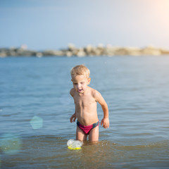 Little boy with snorkel by the sea. Cute little kid wearing mask and flippers for diving at sand tropical beach. Ocean coast.