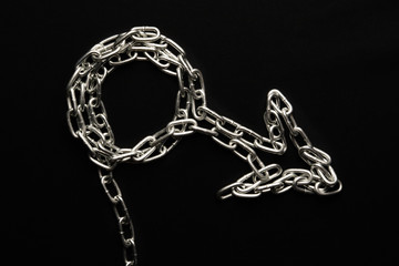 male symbol personifying man, chain in the form of a symbol on a black background