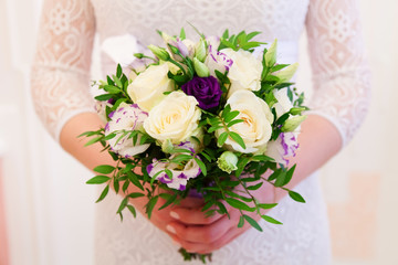 Beautiful wedding bouquet of flowers in bride’s hands
