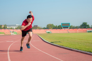 Young asian sporty man running in sport complex center