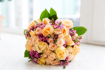 Beautiful bridal bouquet of flowers on the window sill