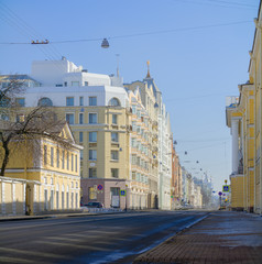 Beautiful view of the city, a simple street. View to the street with the sights of St. Petersburg. Smolny Cathedral in the distance. Street trellis with historical buildings.