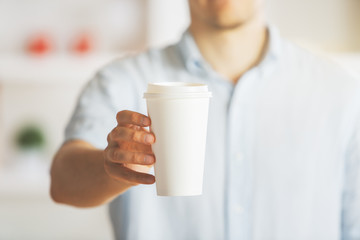 Man holding takeaway coffee cup