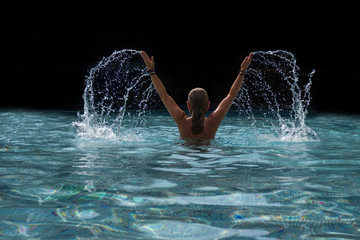 Woman at the swimming pool splattering water