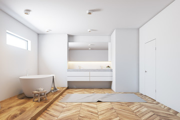 White tile bathroom interior, white tub, wood