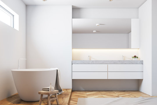 White tile bathroom interior, white tub closeup