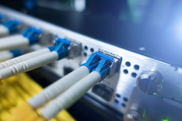 Fiber optic equipment in a data center. Close up fiber optic cable. 