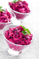 Beet salad. Salad of boiled beet. Beetroot salad with prune, walnuts and sour cream on white background